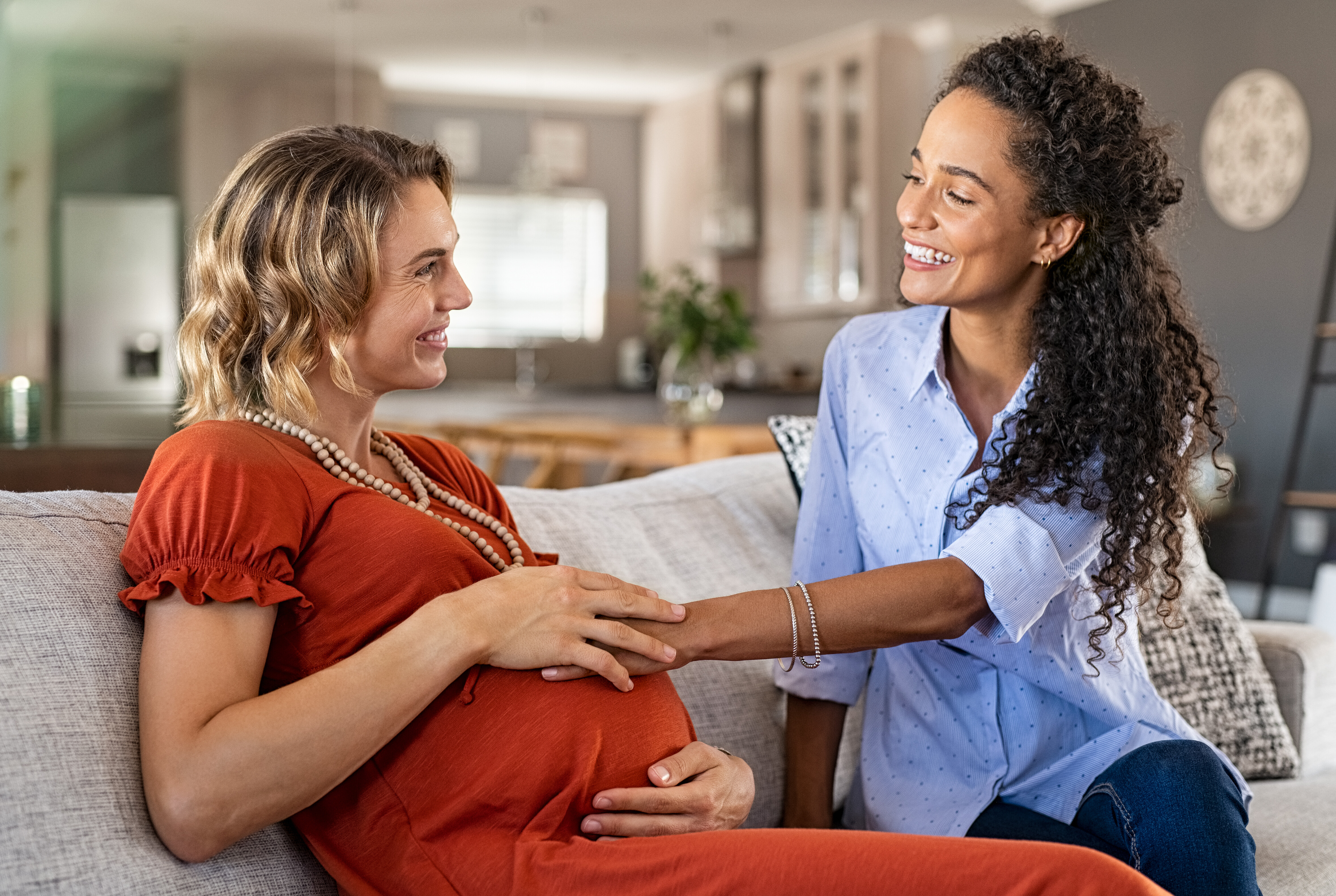 Pregnant Woman Smiling With Friend