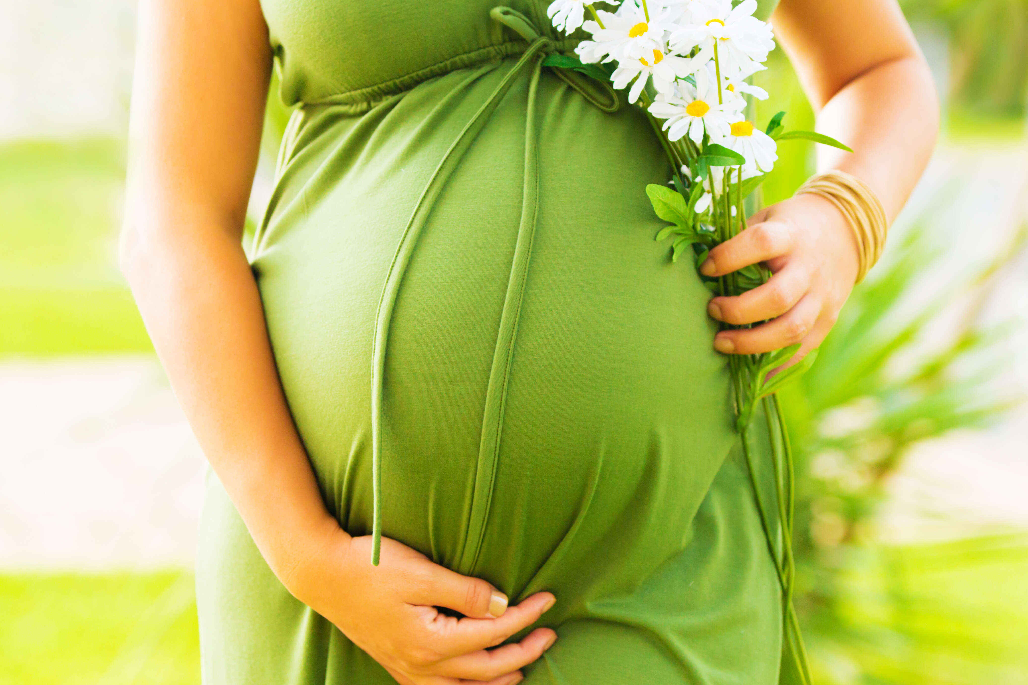 pregnant woman holding flowers