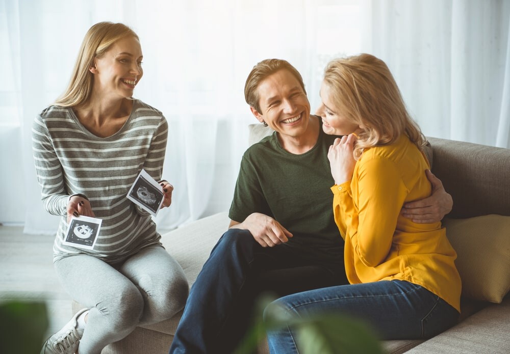 Pregnant Woman a Showing Sonogram to a Couple