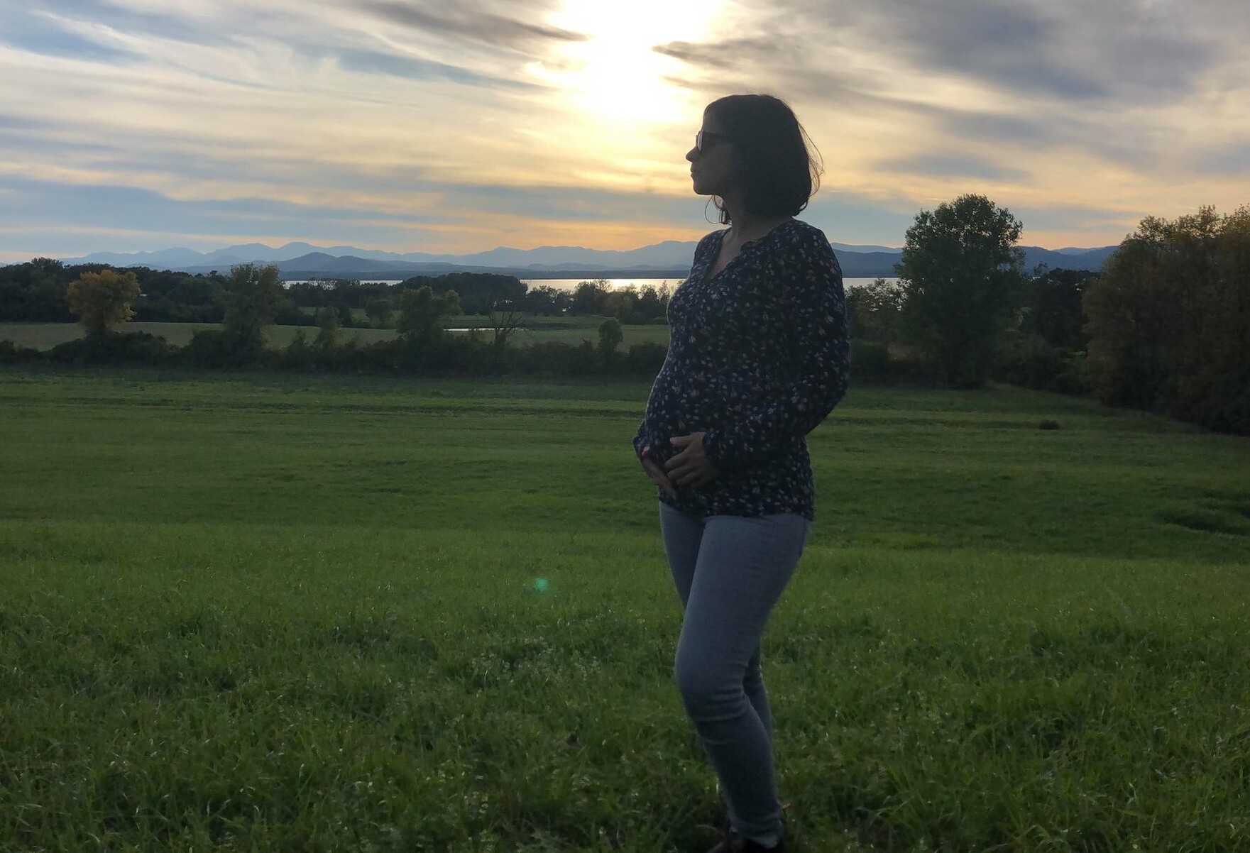 Vermont Surrogacy Network Surrogate standing outside at dusk in Vermont