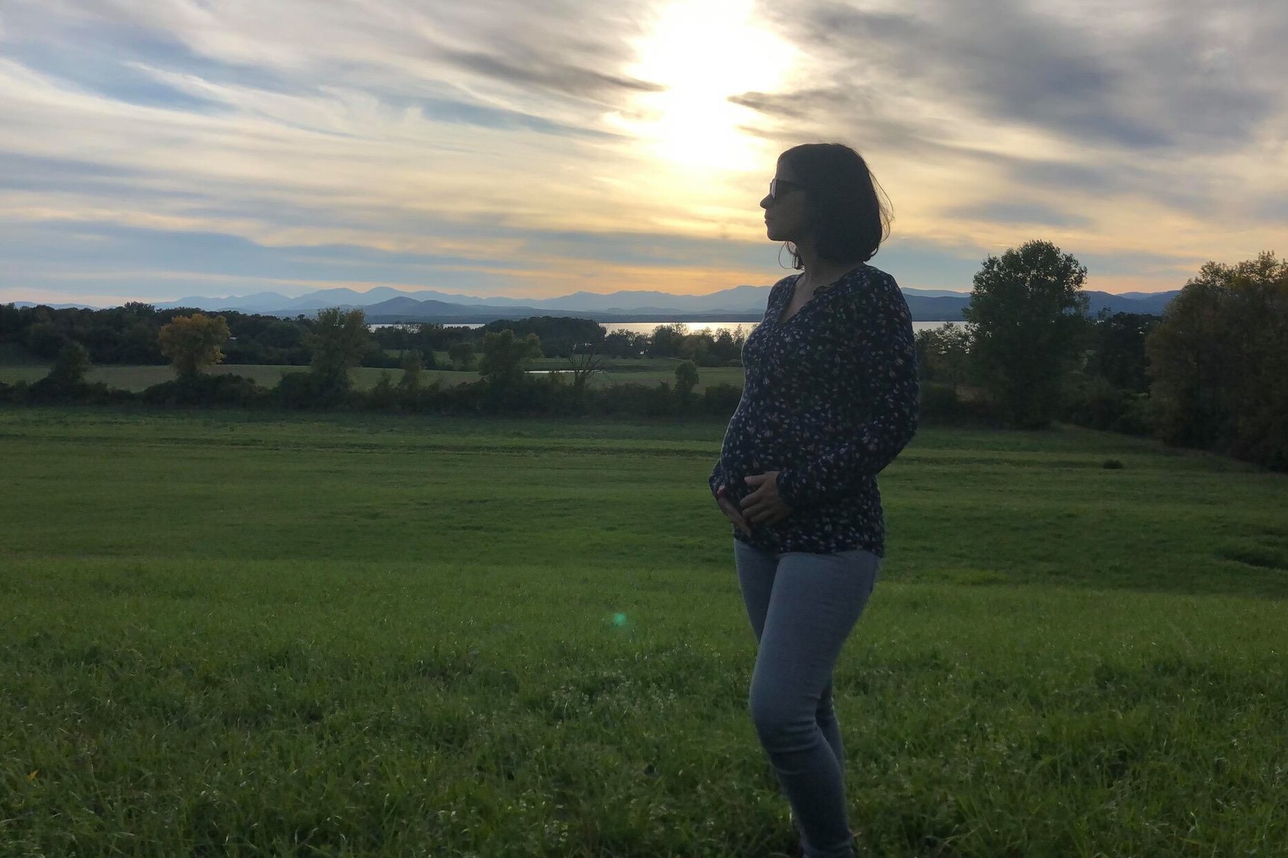 Vermont Surrogacy Network Surrogate standing outside at dusk in Vermont